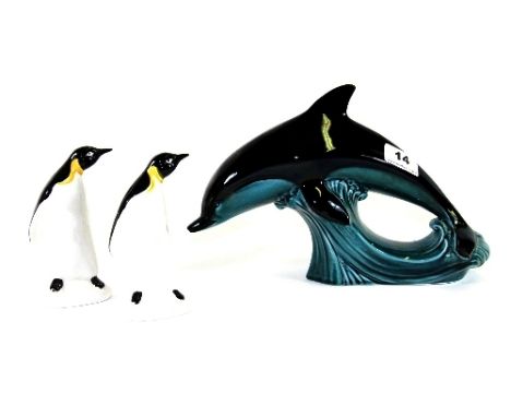 A large Poole dolphin figure and 2 Poole penguins