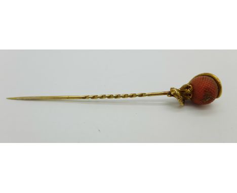 A yellow metal, coral set snake design stick pin, 6.2g