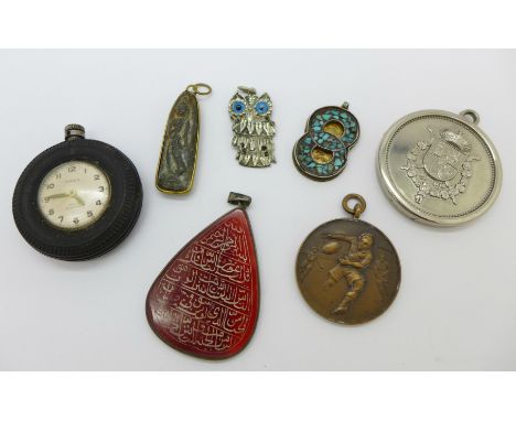 Four pendants, two medallions and a Timex 'tyre' clock