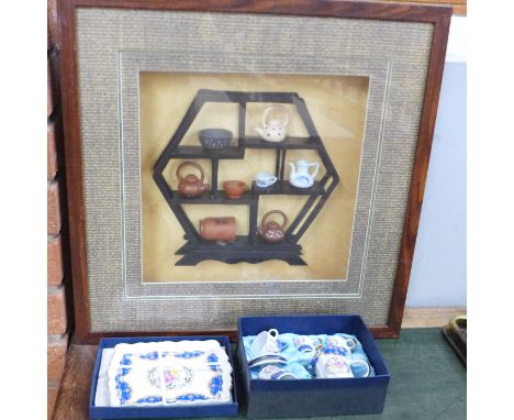 A framed and glazed display of Chinese terracotta and porcelain teawares and a continental china children's tea set, boxed