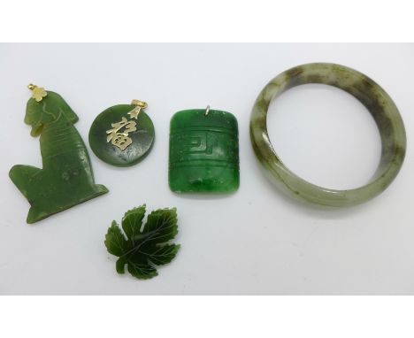A jade bangle, a jade brooch and three pendants