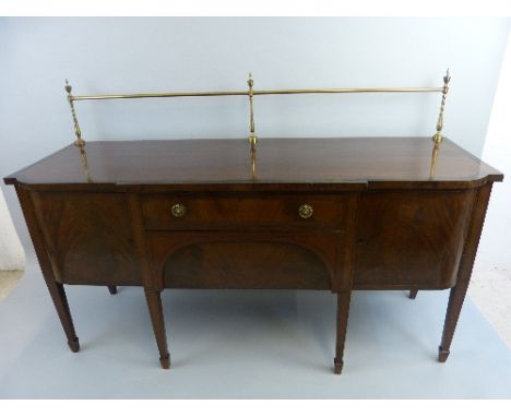 An Edwardian Hepplewhite style mahogany sideboard, with black stained stringing and cross-banding, the bow front top with tur