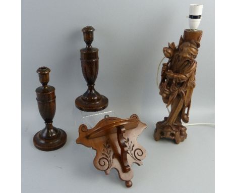 A Chinese hardwood table lamp, carved as an elderly man standing wearing long robes on a pierced base, adapted for electricit