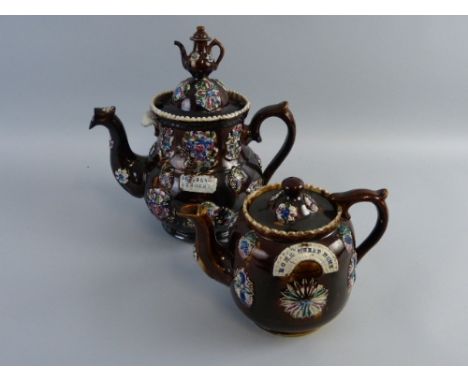 A Victorian bargeware teapot, the bulbous body applied with flowers, fruit and a plaque inscribed 'God Bless Our Home', the l