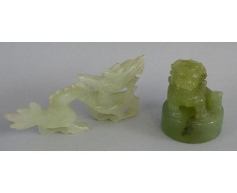 A Chinese jade figure, carved from the solid as a Buddhistic lion seated on a circular base, 7cm high together with another C