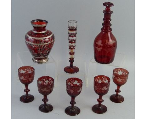 A 19th century ruby flashed decanter, of mallet shaped form with ringed neck and mushroom stopper, 19cm high, set of five rub