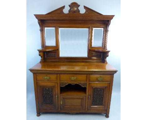 An Edwardian walnut sideboard, the high mirror back with fan carved broken arch pediment on dentil cornice over a central squ
