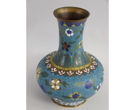 A Chinese cloisonne enamel vase, of bottle shaped form with a flower head and leaf pattern on a turquoise blue ground, 21cm h