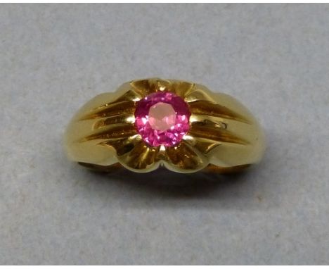 An 18ct gold single stone ruby ring, split claw set with a circular cut stone of approximately 1cts, size R.