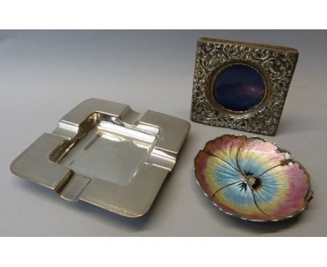 A silver square  ashtray, by Mappin & Webb, Birmingham 1931, with engine turned decoration, a silver and enamel floral dish, 