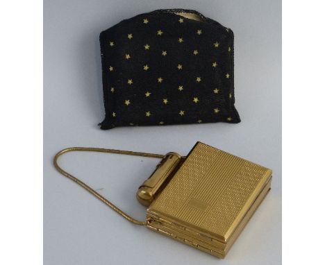 A Lady's Kigu gilt metal combined compact and cigarette case, of oblong form with engine turned front and back, applied lipst