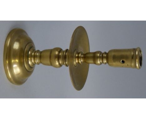 An 18th century brass Helmskirk candlestick, of baluster form with wide drip pan and domed foot, 19cm high
