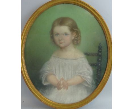 Late 19th/early 20th century school, portrait of a girl in a white dress seated on a turned knop chair, unsigned pastel, oval