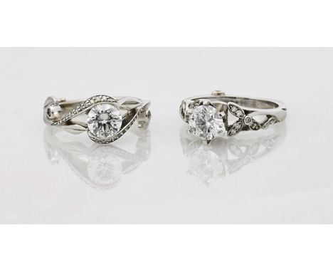 Two 14K White Gold Engagement RingsTwo 14K white gold engagement rings; each centering a round-cut cubic zirconia, with pavé 
