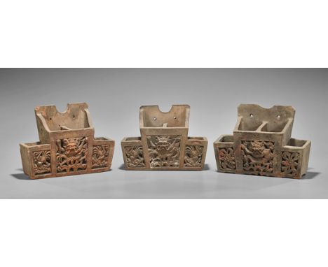 Three Antique Chinese Pottery HoldersThree antique Chinese moulded pottery holders; with four sections, the middle with a rai