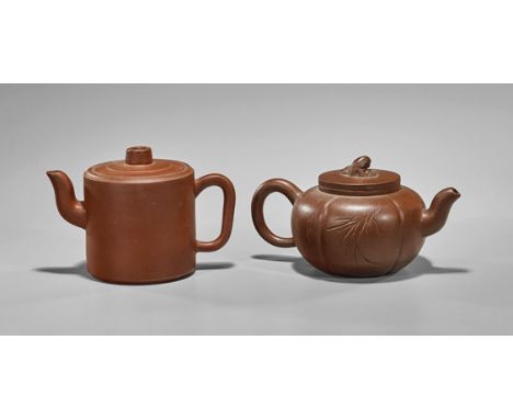 Two Chinese Yixing Pottery TeapotsTwo Chinese yixing pottery teapots: one of simple cylindrical form ; together with a squat 