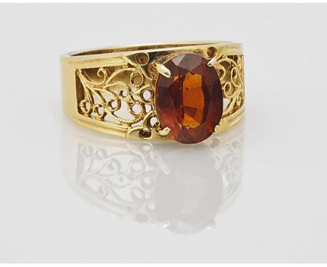 Ladies' 18K Gold & Garnet RingLadies 18K yellow gold ring; set with large deep orange faceted oval cut garnet in a prong sett