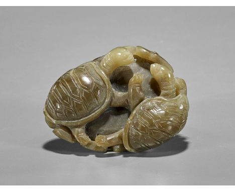 Carved Celadon Jade Turtle GroupChinese carved celadon jade toggle; depicting two turtles resting on a lotus pad; D: 2 3/4"
