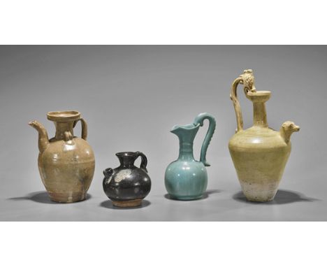 Four Chinese Dynastic Glazed EwersFour Chinese Tang/Ming Dynasty glazed pottery ewers: pale yellow ovoid form with dragon bod