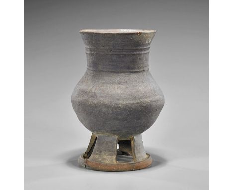 Three Asian Pottery and Stoneware VesselsKorean Silla Dynasty footed bulbous form stoneware jar; antique Chinese green glazed