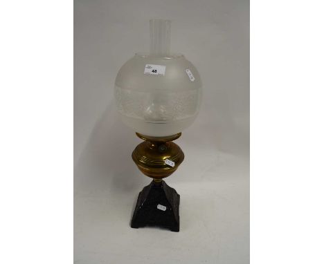 BRASS AND CAST IRON BASED OIL LAMP WITH OPAQUE GLASS SHADE