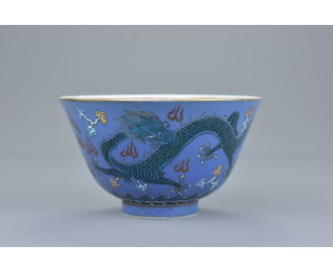 A quality Chinese mid 19th century powder blue ground Famille rose porcelain tea bowl decorated with two dragons chasing a pe