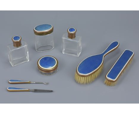 A set of eight English early 20th century guilloche enamel and glass vanity set. (8)
