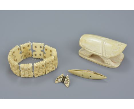 A carved ivory figure of a beetle together with a 19/20th century butterfly brooch with mother of pearl inserts, a sewing ite