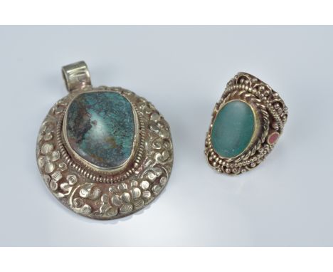 One Tibetan white metal pendant with large turquoise coloured stone insert with floral decoration in relief together with a w