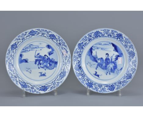 A pair of 18th century Kangxi period blue and white porcelain dishes decorated with hunting scenes showing a female rider cha