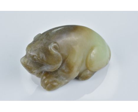 A Chinese pale green and brown jade carving of a seated bear. 8Cm length