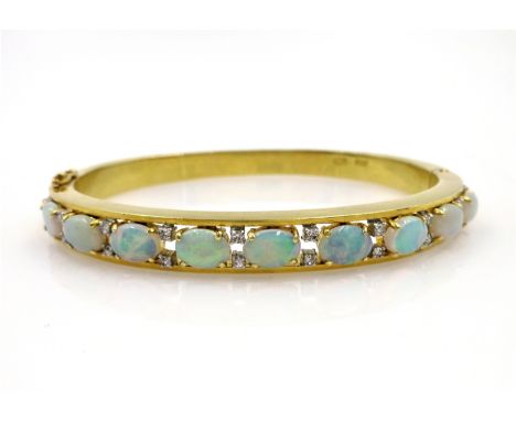 Opal and diamond gold hinged bangle, nine opals, twenty diamonds stamped 18k 750, 34gm    Condition Report   Click here for f