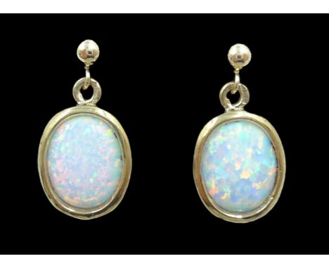 Pair of 9ct gold opal pendant ear-rings stamped 375   Condition Report  Approx 1.6gm,1.7cm m length  Click here for further i