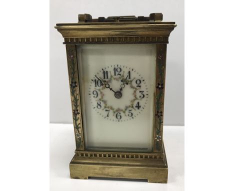 A circa 1900 French lacquered brass cased carriage clock with floral and foliate enamel decorated swags to the chapter ring w