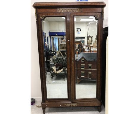 A 19th Century French mahogany double mirror door wardrobe or armoire in the Louis XVI taste, the shallow caddy top over a lo