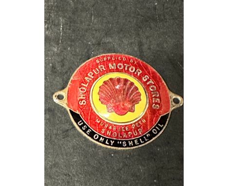 An enamel supplier dashboard plaque, badge, emblem with early Shell logo to centre, for Sholapur Motor Stores. 'Use Only "She