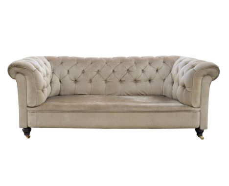 Victorian chesterfield, with light faun upholstery, button backed, on turned legs with casters, 79cm high x 194cm wide x 83cm