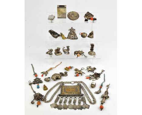 A number of Asian or other white metal sculpture, applique, or small cabinet objects, including a rectangular amulet case on 