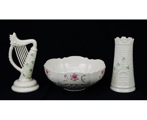 Belleek model of a harp, 22cm high, together with a turret vase, moulded with shamrock leaves, a candle stick, four tea light