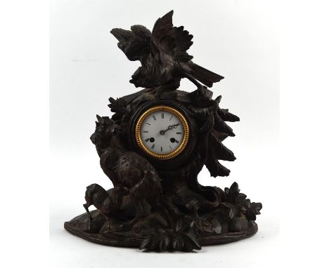 German Black Forest clock, 19th Century, carved with a bird and a pair of sheep, in a wooden landscape, the white enamel dial