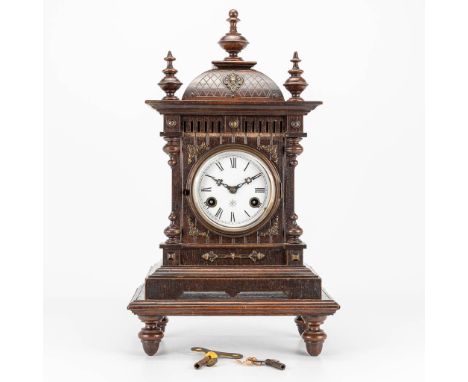 A vintage table clock marked Junghans and made in Germany. The first half of the 20th century. (16 x 27 x 45 cm)