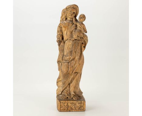 A wood sculptured Madonna with child. The first half of the 18th century. (10 x 12 x 44 cm)