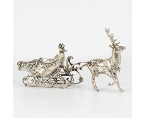 A reindeer with a sled, made of silver and marked. 344g. (26 x 12 cm)