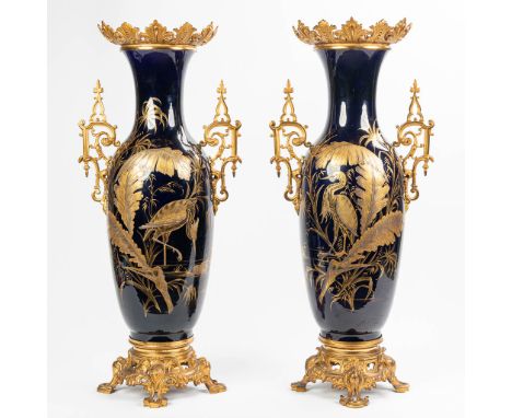 An exceptional pair of vases made of porcelain with Kobalt-blue glaze and hand-painted Japanese decor mounted with bronze. De