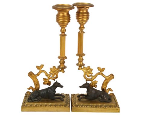 A pair of gilt-bronze candlesticks with hound figures, height 25cm 