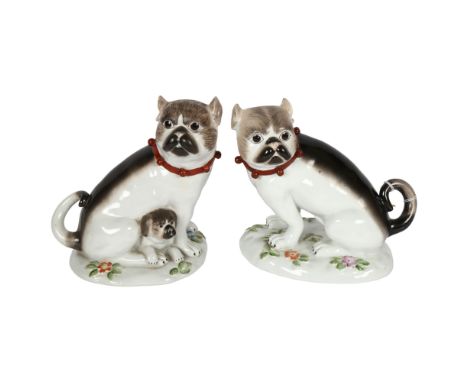 A pair of German ceramic Pugs, on floral decorated bases, height 19cm 