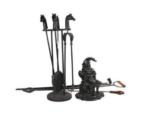 A fire companion set with horse head finials, a walking stick, Mr Punch doorstop etc 