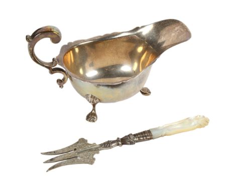 A George VI silver cream jug, Birmingham 1937, and an Edward VII silver and mother-of-pearl handled bread fork with engraved 