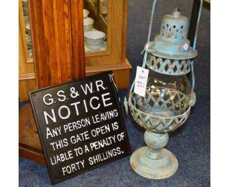 A small cast iron railway sign, 27 x 17cm, together with a paraffin lamp, 55cm high (2)