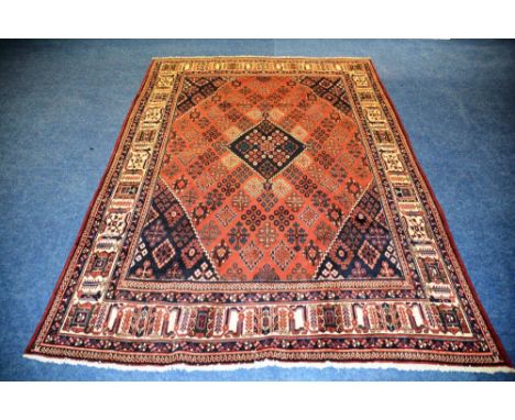 A Persian Meimeh carpet, the central diamond over red ground with gul design, spandrels and border, 345 x 235cm